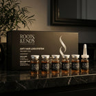 Roots & Ends box with six vials on a black marble shelf