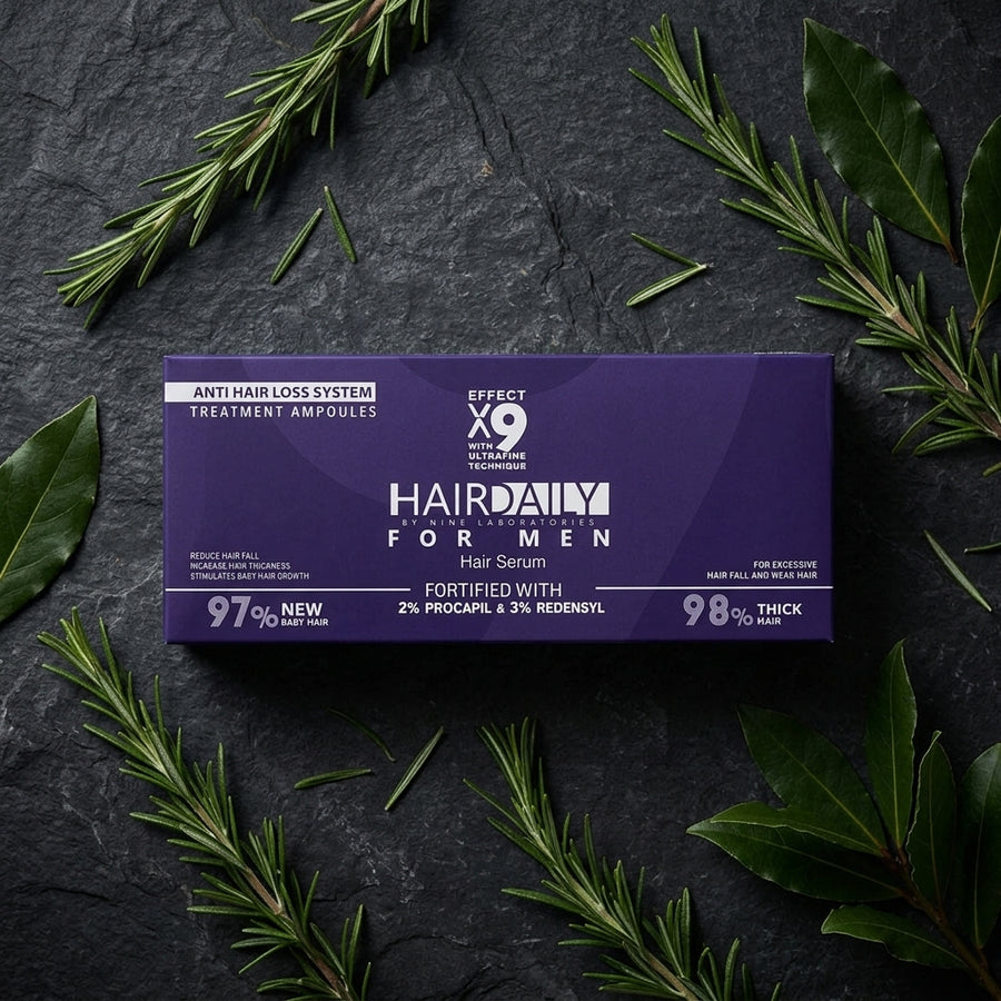 علبة Hair Daily للرجال على سطح حجر غامق مع أغصان روزماري