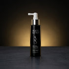 Roots & Ends spray bottle on a dark surface