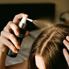 Spraying Roots & Ends onto the scalp at the parting